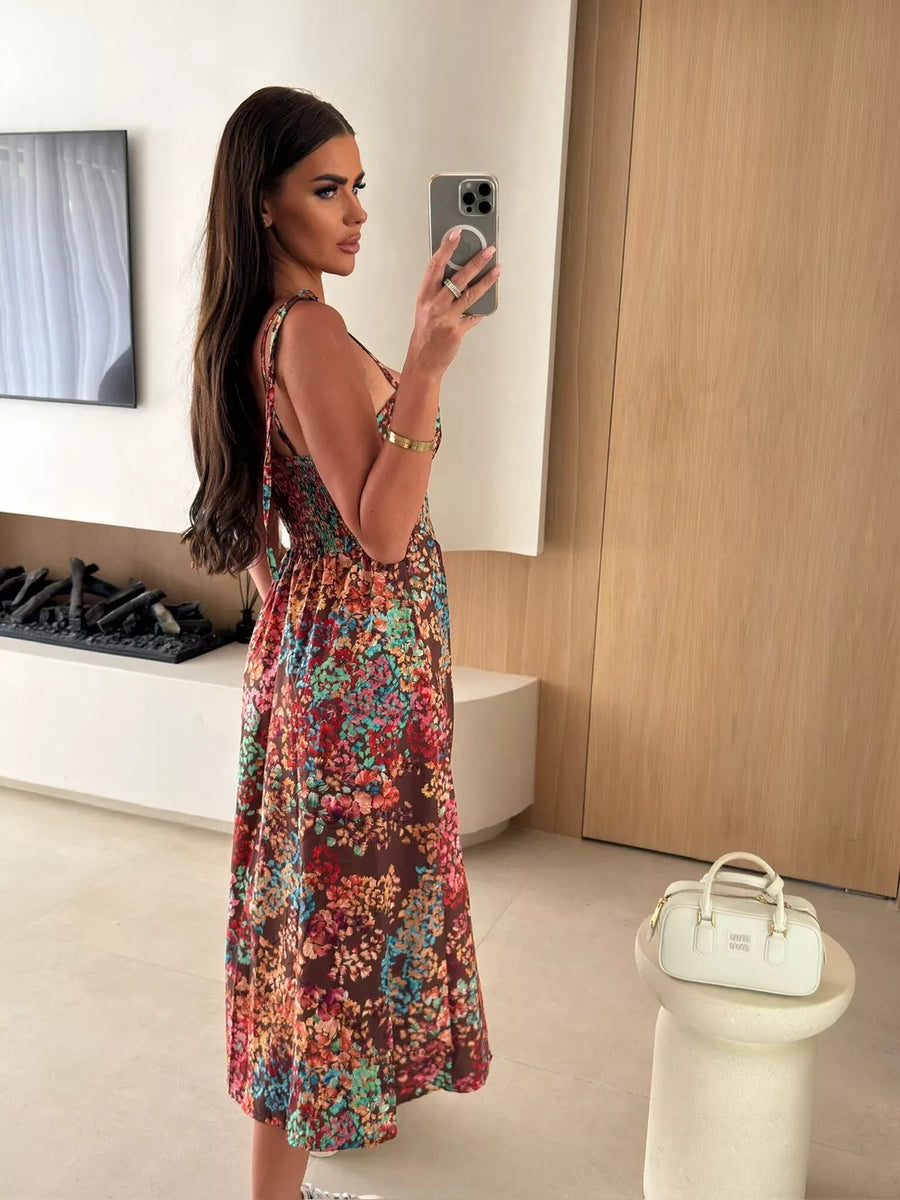 Floral tie-strap midi dress in brown with a multicolor floral print, A-line skirt.