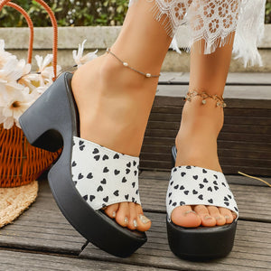 Playful heart print block heel sandals in gray/white and black with platform sole.