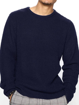 Navy waffle knit crewneck sweater with relaxed fit and long sleeves.