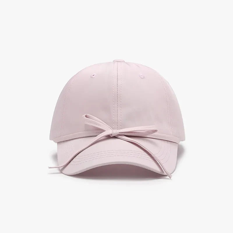 Blush pink baseball cap with a tied back bow detail
