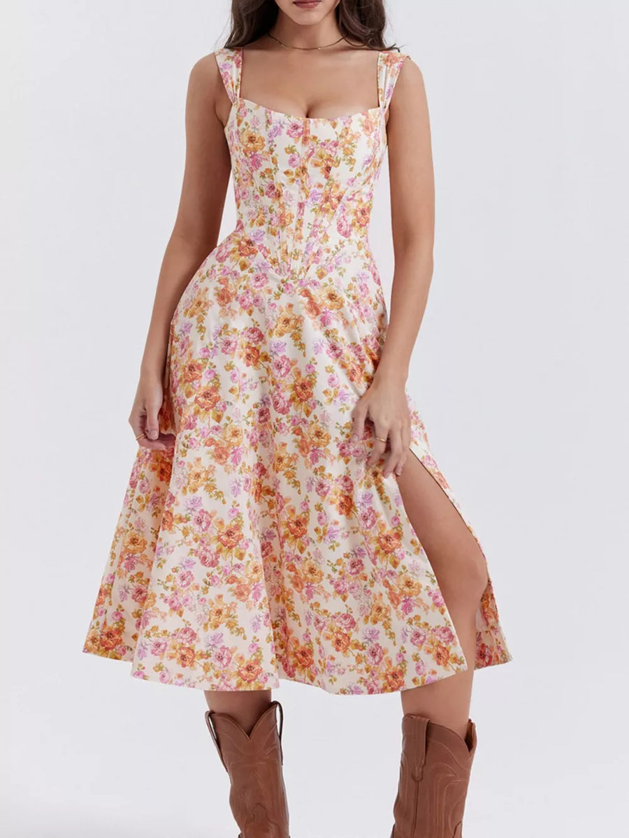 Floral midi dress with side slit and sweetheart neckline in cream with pink and orange flowers.