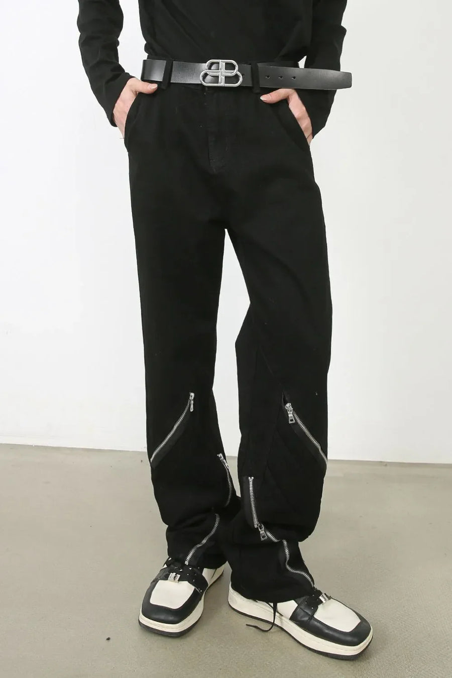 Zipped hem black denim trousers with silver zipper details.