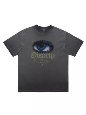 Grey graphic t-shirt with an eye print and text that says Observe