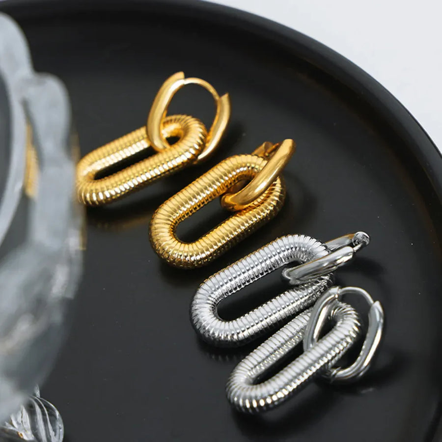 Textured oval link earrings in gold and silver with ribbed detail.