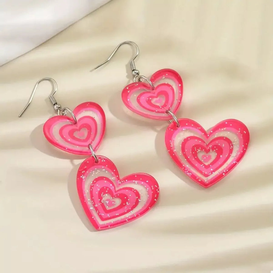 Pink layered heart dangle earrings with glitter detail