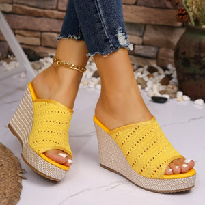Yellow perforated espadrille wedge sandals with woven wedge heel and open toe.