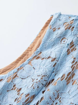 Blue lace dress with floral pattern and tan lining detail.