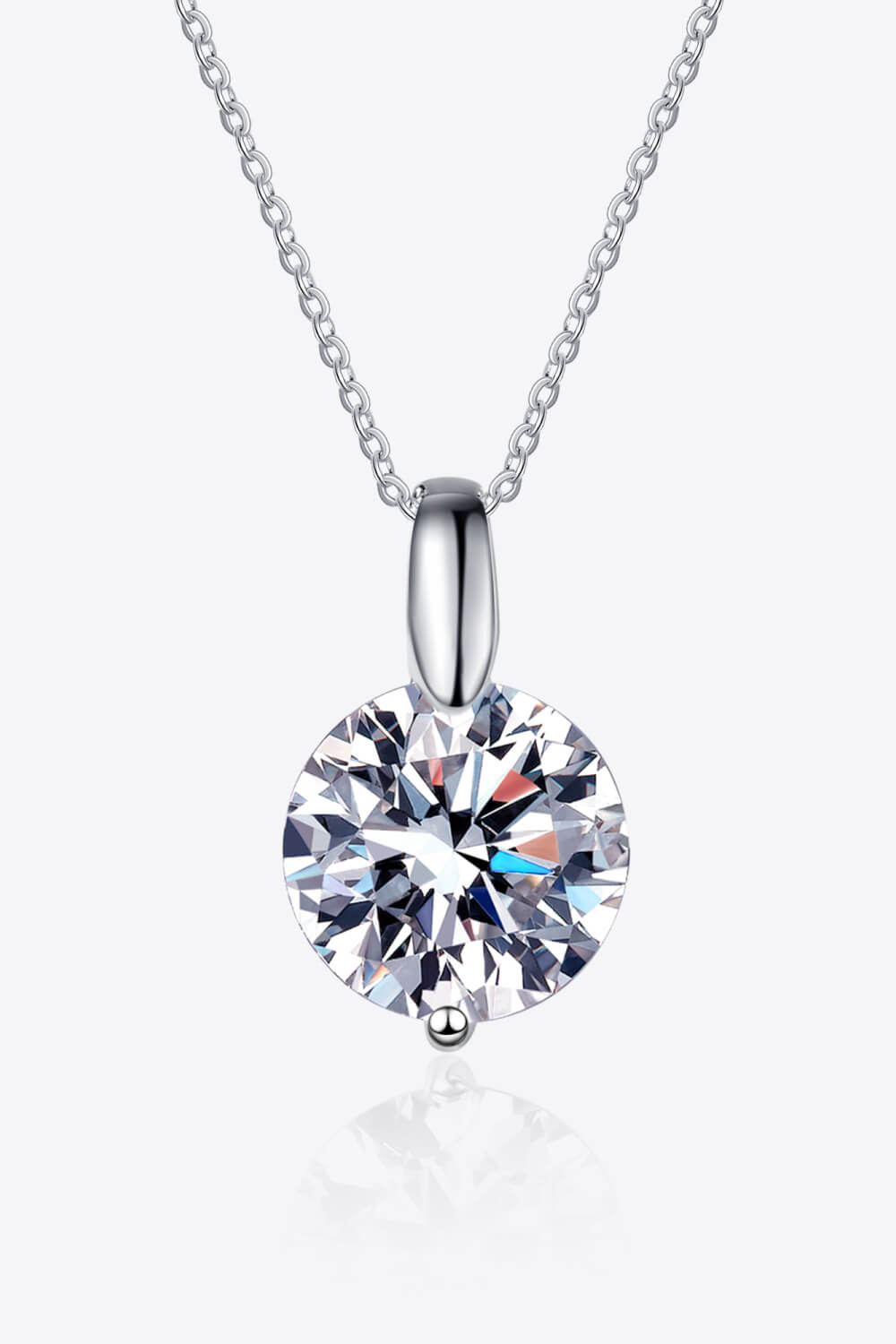 Silver solitaire moissanite pendant necklace with a round cut stone.