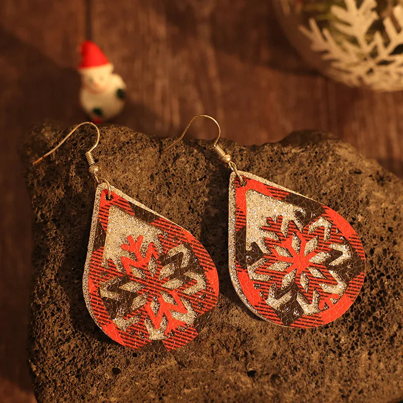 Plaid snowflake drop earrings in deep red with glitter accents.