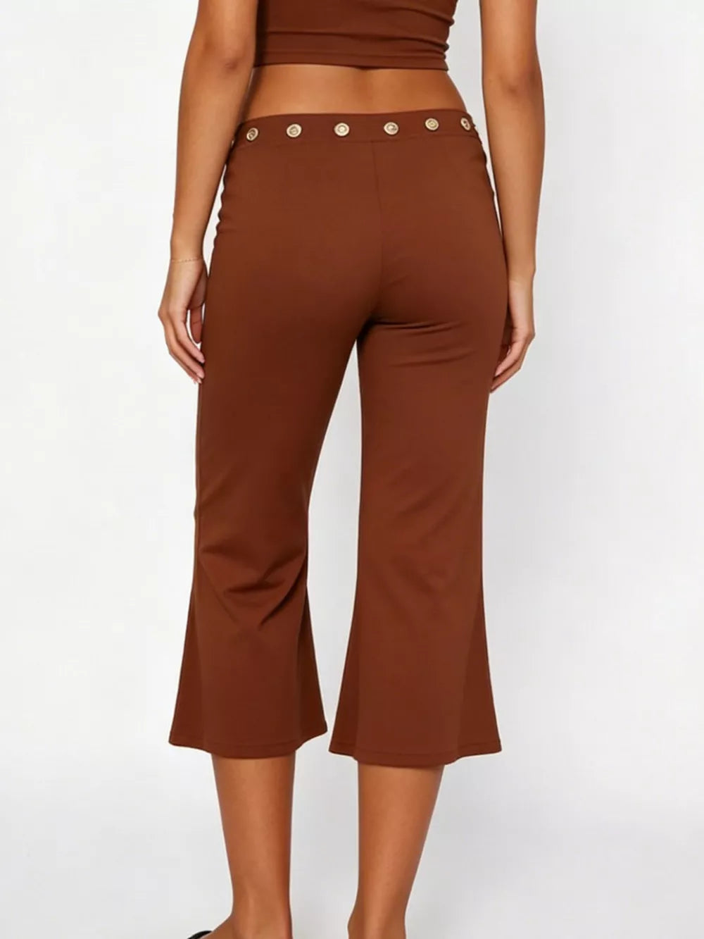 Dark brown maternity capri pants with flared hem and button detail at the waist