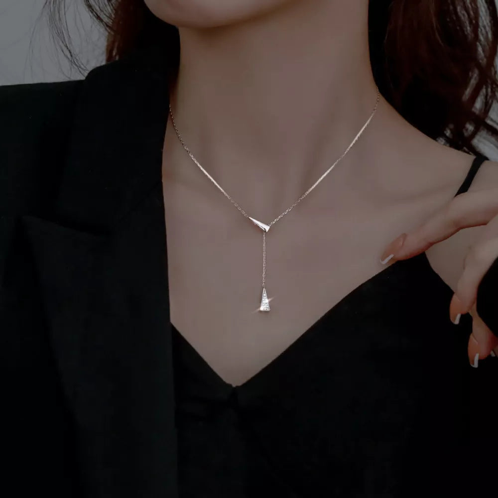 Sleek sterling silver Y necklace with a geometric triangle pendant and delicate chain.