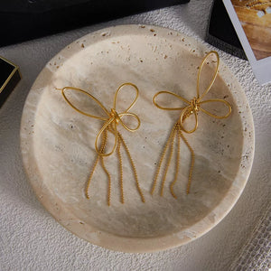 gold earrings with bow design and N/A