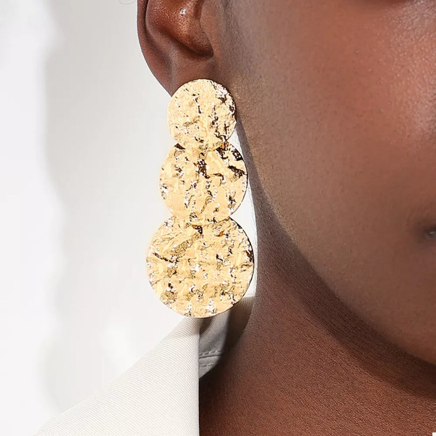 earrings in gold with textured and layered