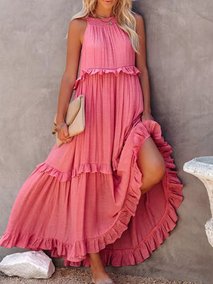 Pink ruffled maxi dress with smocked neckline and tiered skirt.