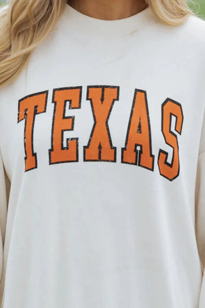 White crewneck sweatshirt with distressed orange "TEXAS" graphic