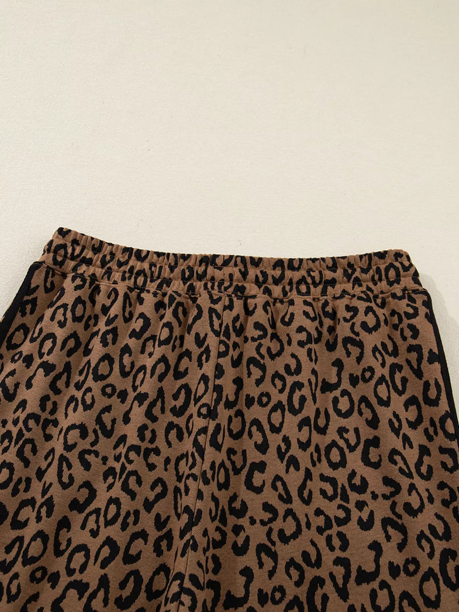 Brown leopard print joggers with elastic drawstring waist and black side stripe detail.