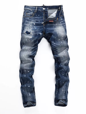 Men's dark blue distressed slim-fit jeans with paint splatter detail and ripped knee.
