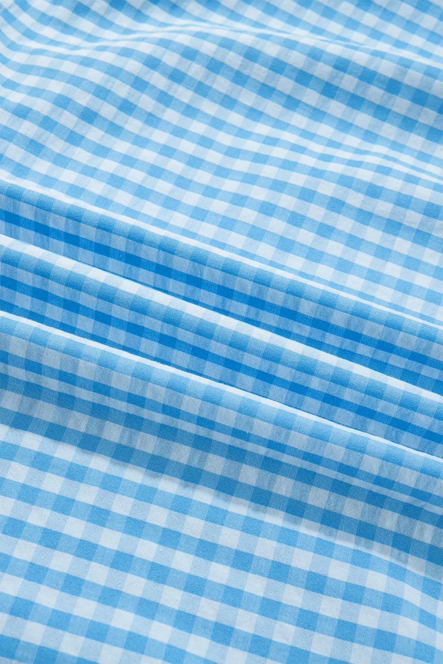 Ruffled tiered maxi dress in blue and white gingham polyester with knot back detail.