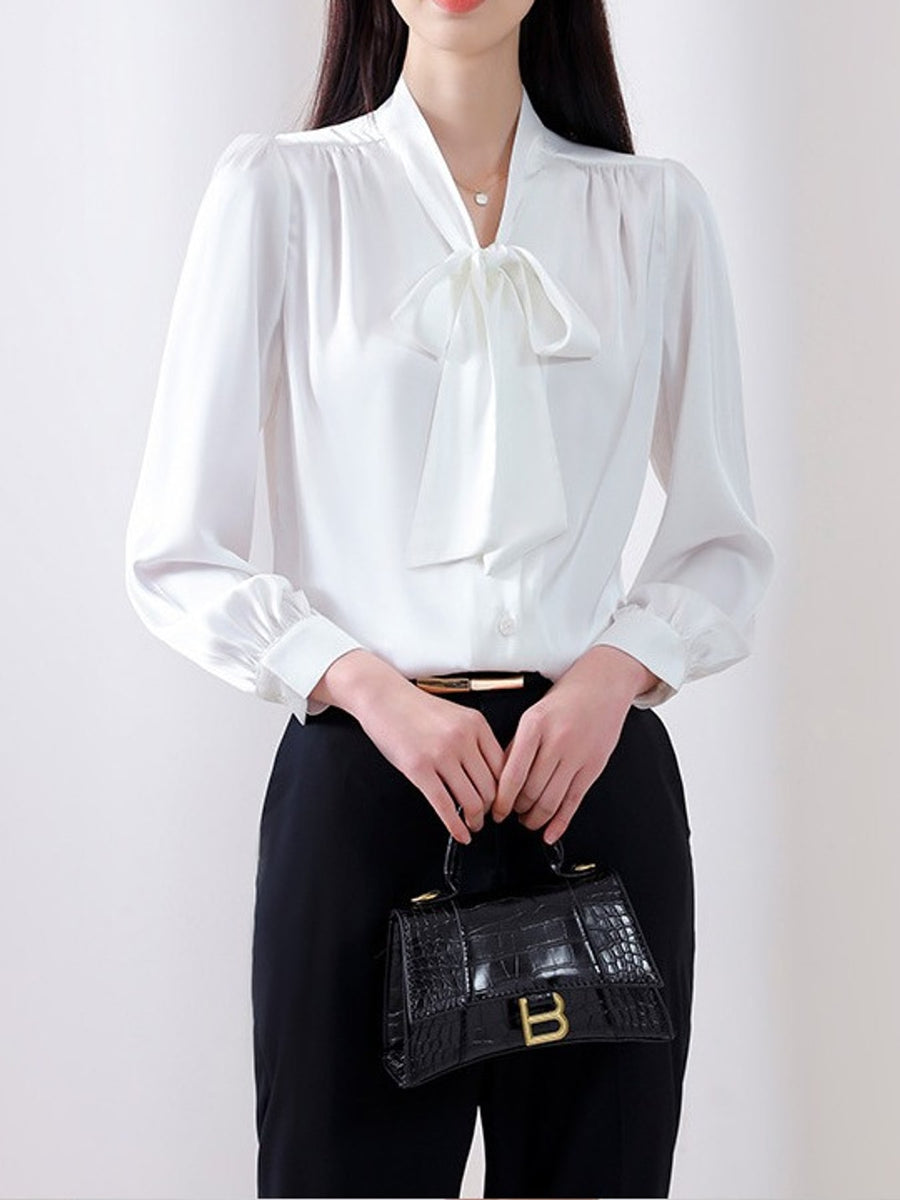 blouse in white featuring bow and relaxed fit