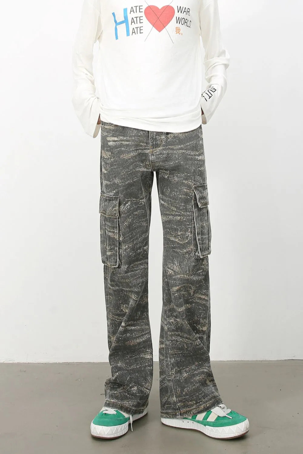 Distressed camo wide-leg cargo jeans in dark gray with multiple pockets.