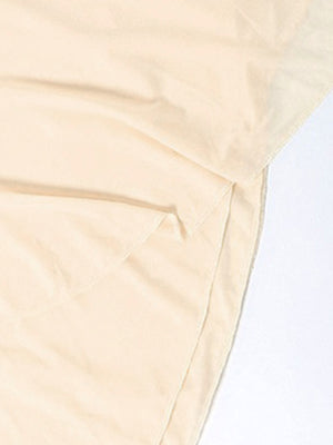 Backless ruffled mini dress in beige with asymmetrical hem detail
