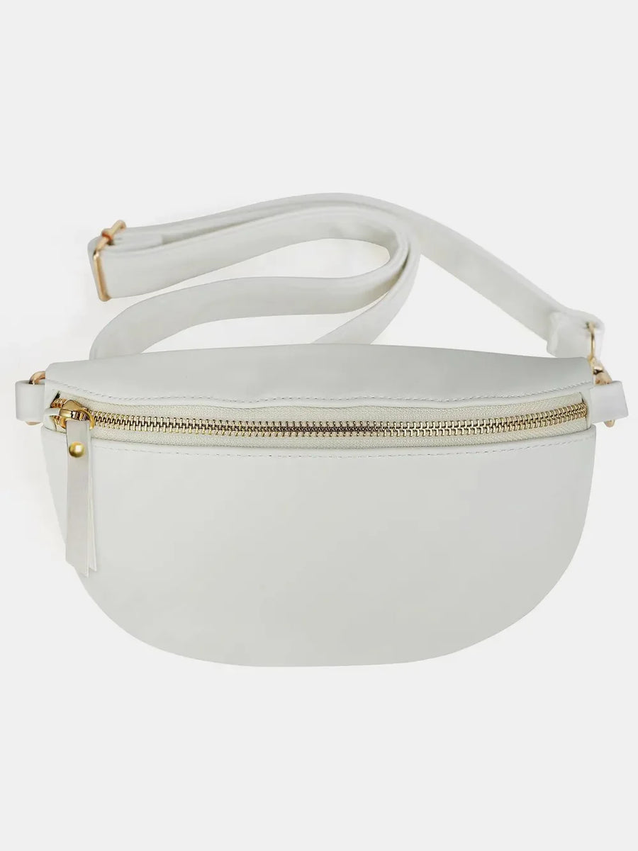 White faux leather curved zip belt bag with gold hardware and adjustable strap.