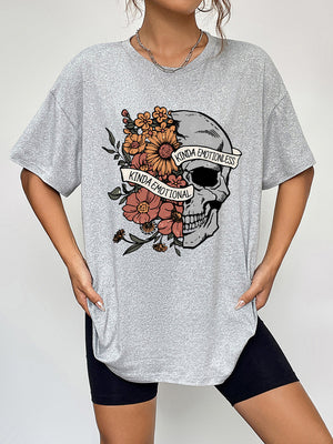 Grey oversized t-shirt with a skull and floral graphic that says Kinda Emotional.