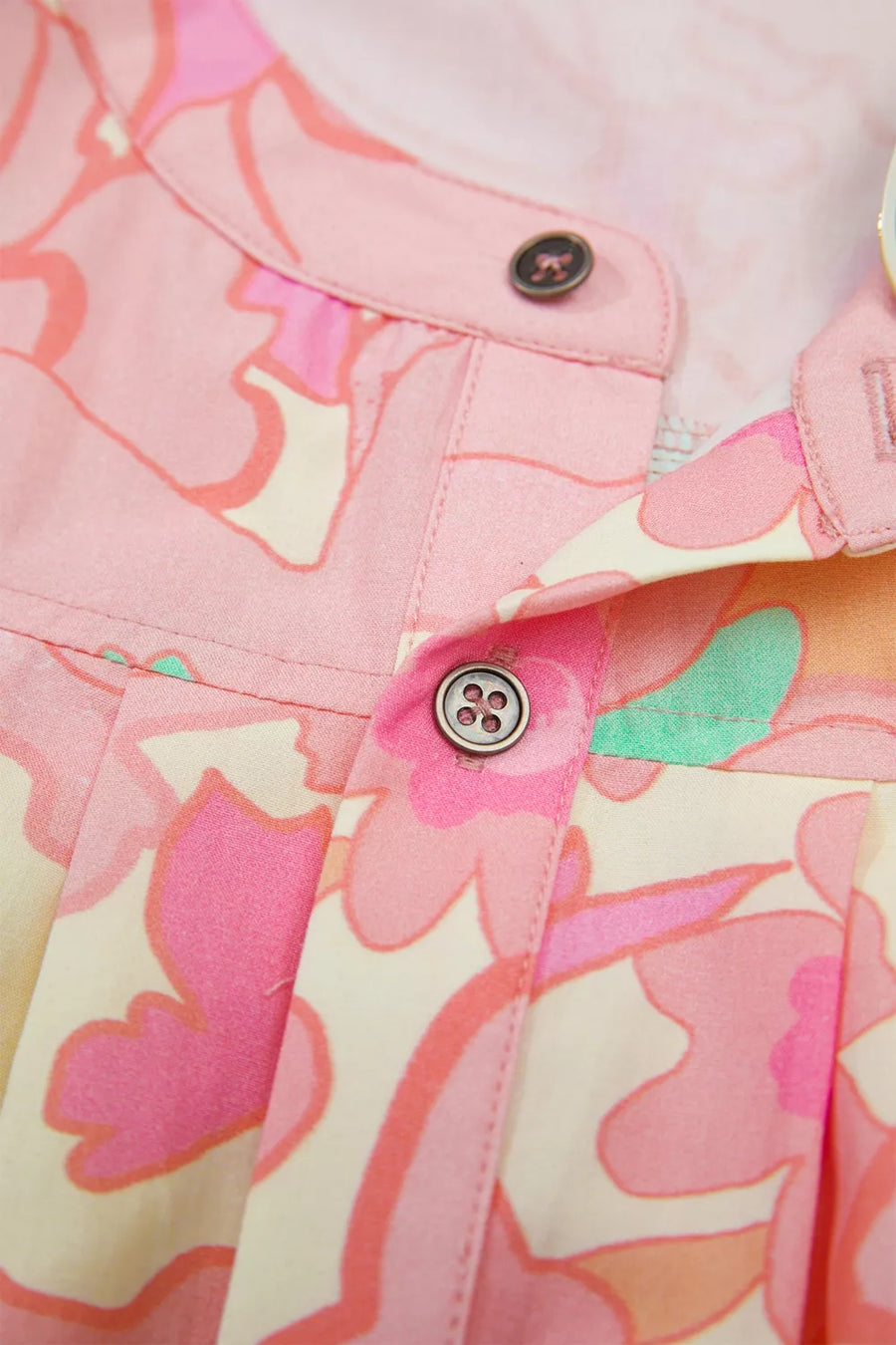 Retro floral short sleeve shirt with band collar and button-down front in pink and cream.