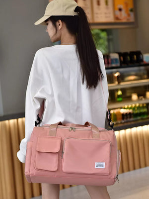 Pink Oxford cloth travel organizer bag with multiple pockets and detachable strap.