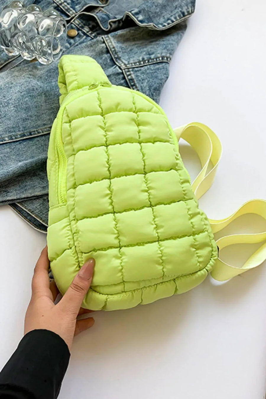 Padded sling bag in Yellow Green with quilted pattern and top handle.