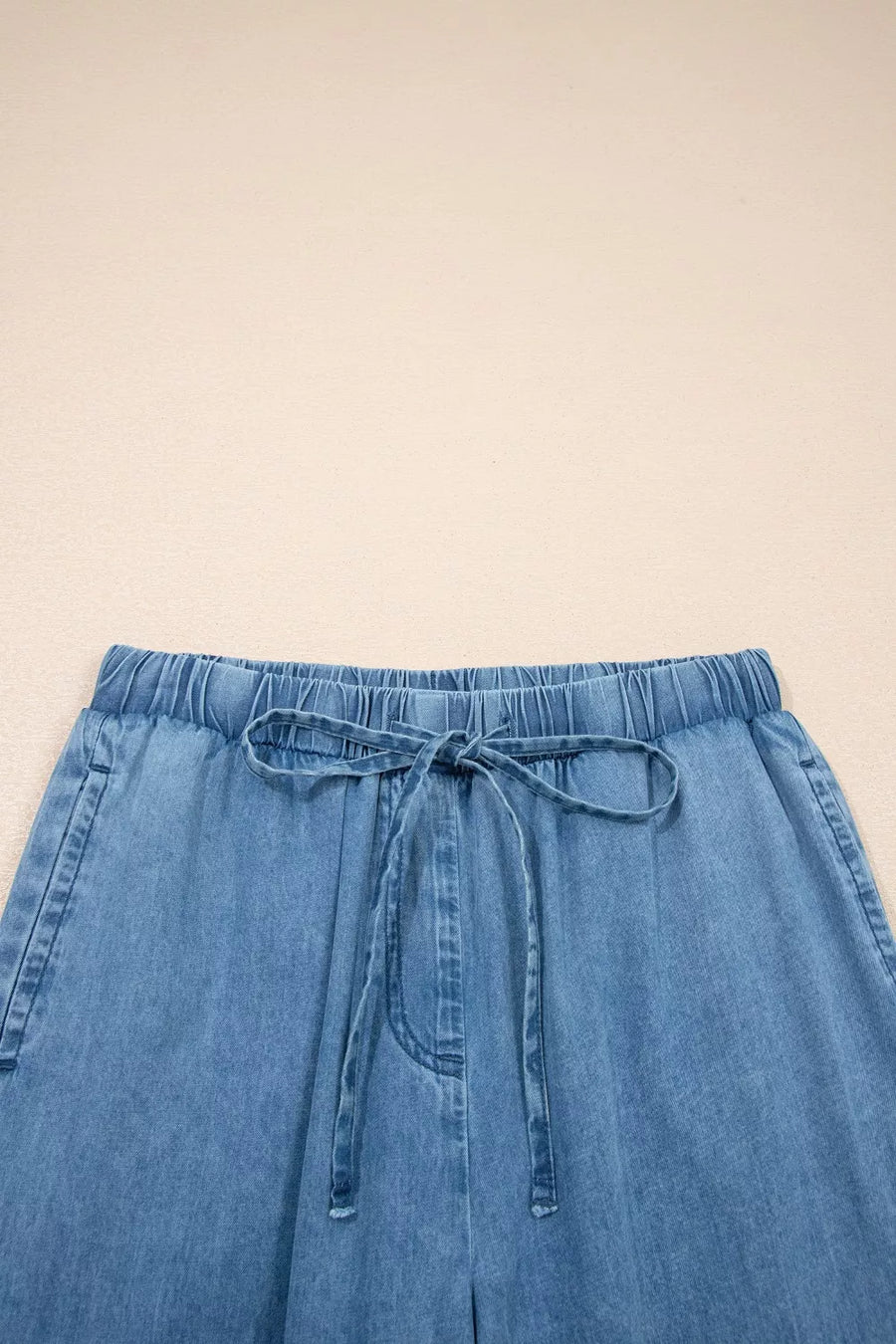 Maternity wide-leg chambray jeans with elastic waistband and drawstring.