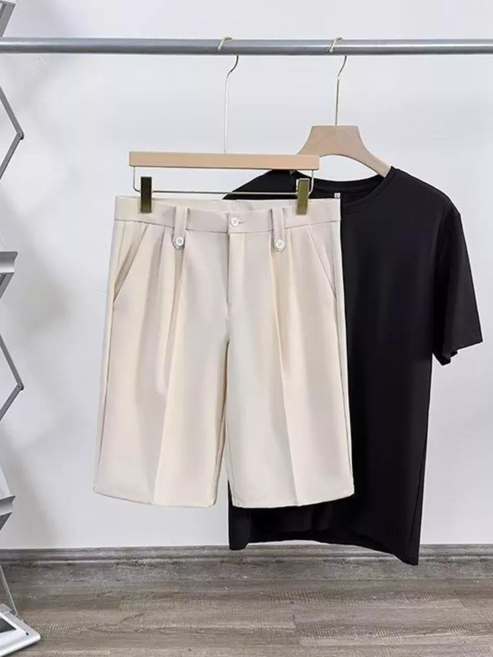 Tan pleated chino shorts with pockets and a black t-shirt.