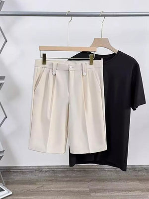 Tan pleated chino shorts with pockets and a black t-shirt.