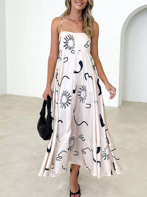 Artistic spaghetti strap maxi dress in ivory with black abstract sun and line print.