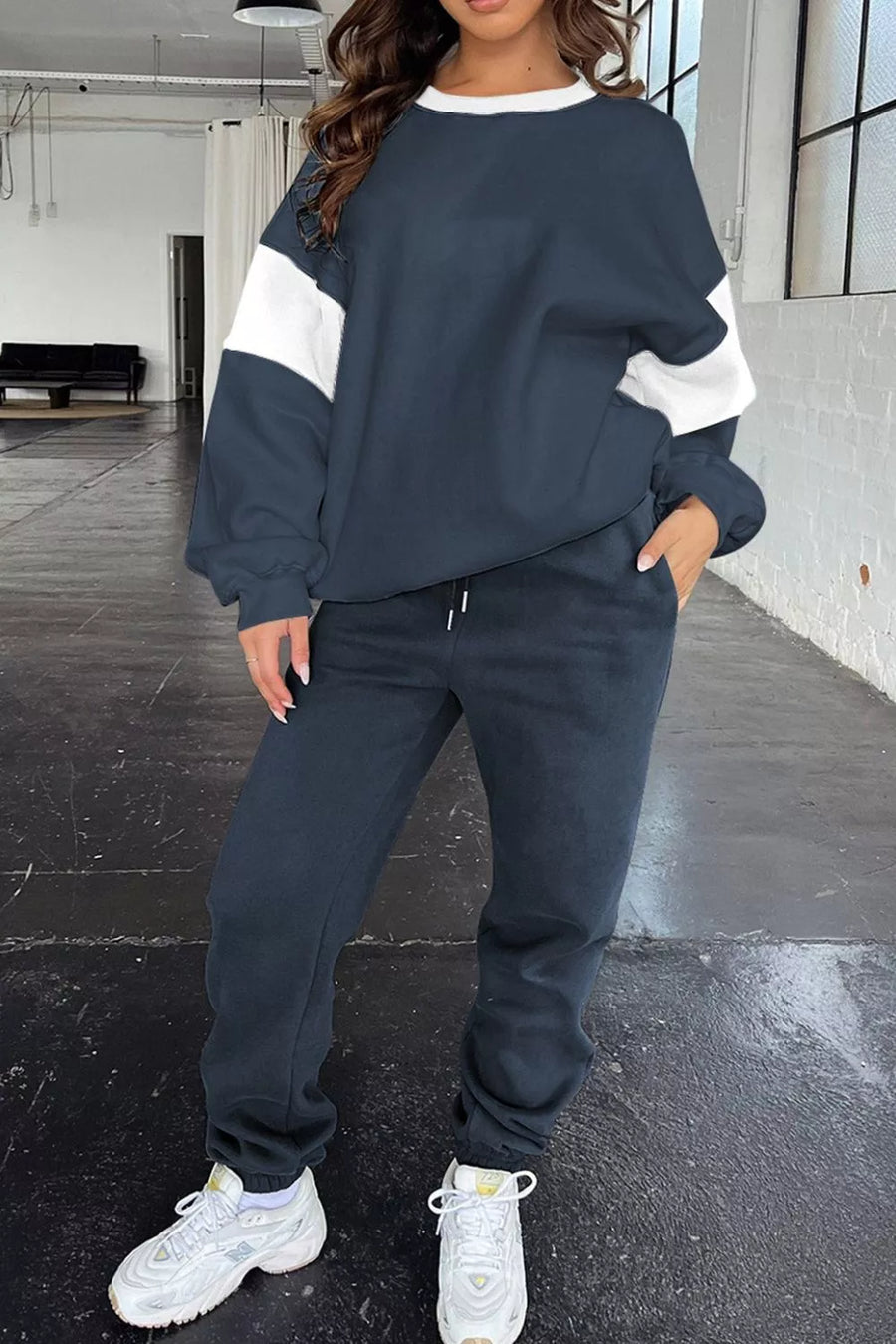 Navy active set with white contrast stitching on sleeves and neckline, paired with matching sweatpants.