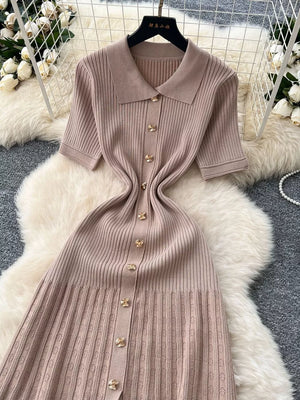 Apricot knit Peter Pan collar dress with gold buttons and short sleeves.