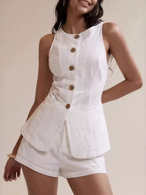 White cotton two-piece set with decorative buttons and shorts.