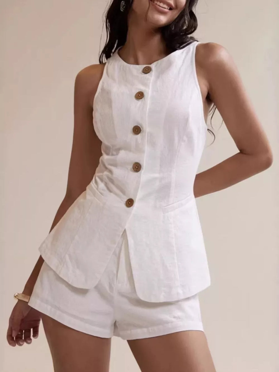 White cotton two-piece set with decorative buttons and shorts.