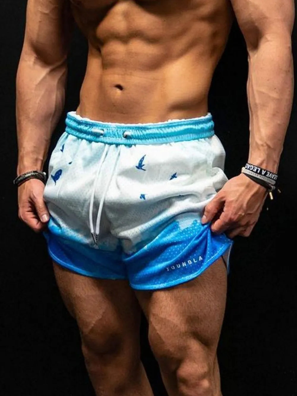 Mesh athletic shorts in sky blue with a bird and wave print, drawstring waist.