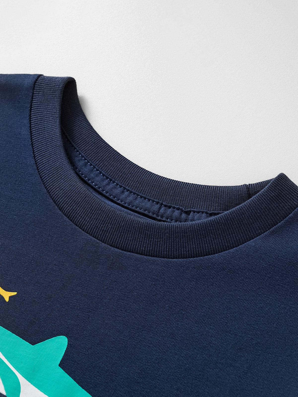 Navy cotton crew neck t-shirt with a whimsical shark print detail.