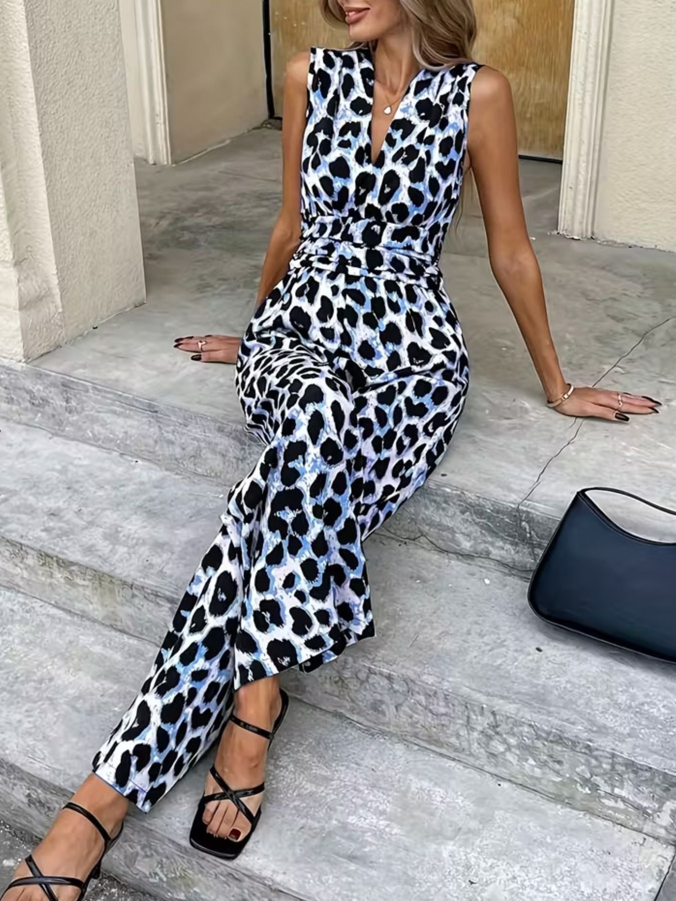 Chic sleeveless leopard print romper with V-neck and wide legs.