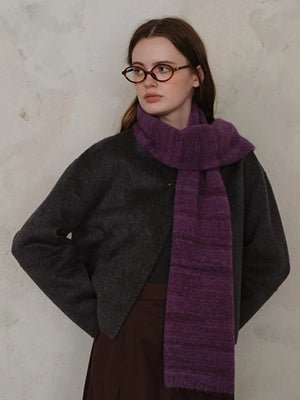 Textured mélange knit scarf in Deep Purple, styled with a dark gray jacket.