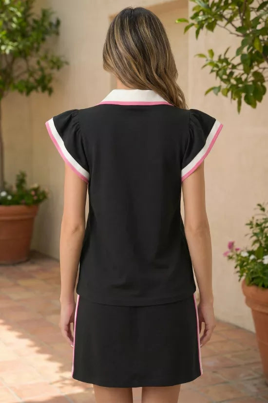 Black blouse with contrast trim collar and sleeves, paired with a black skirt with pink stripe detail.