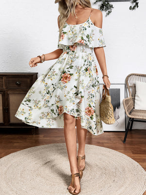 Floral print cold shoulder dress with ruffled trim and high-low hem.