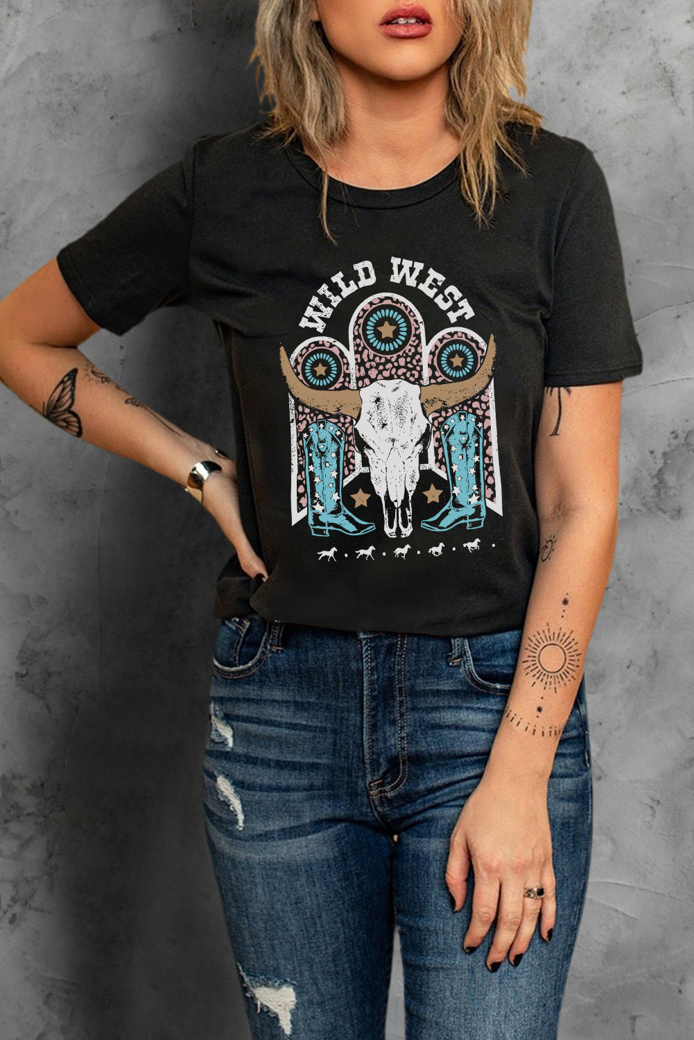 Black crewneck tee with a Wild West graphic featuring a bull skull and cowboy boots.