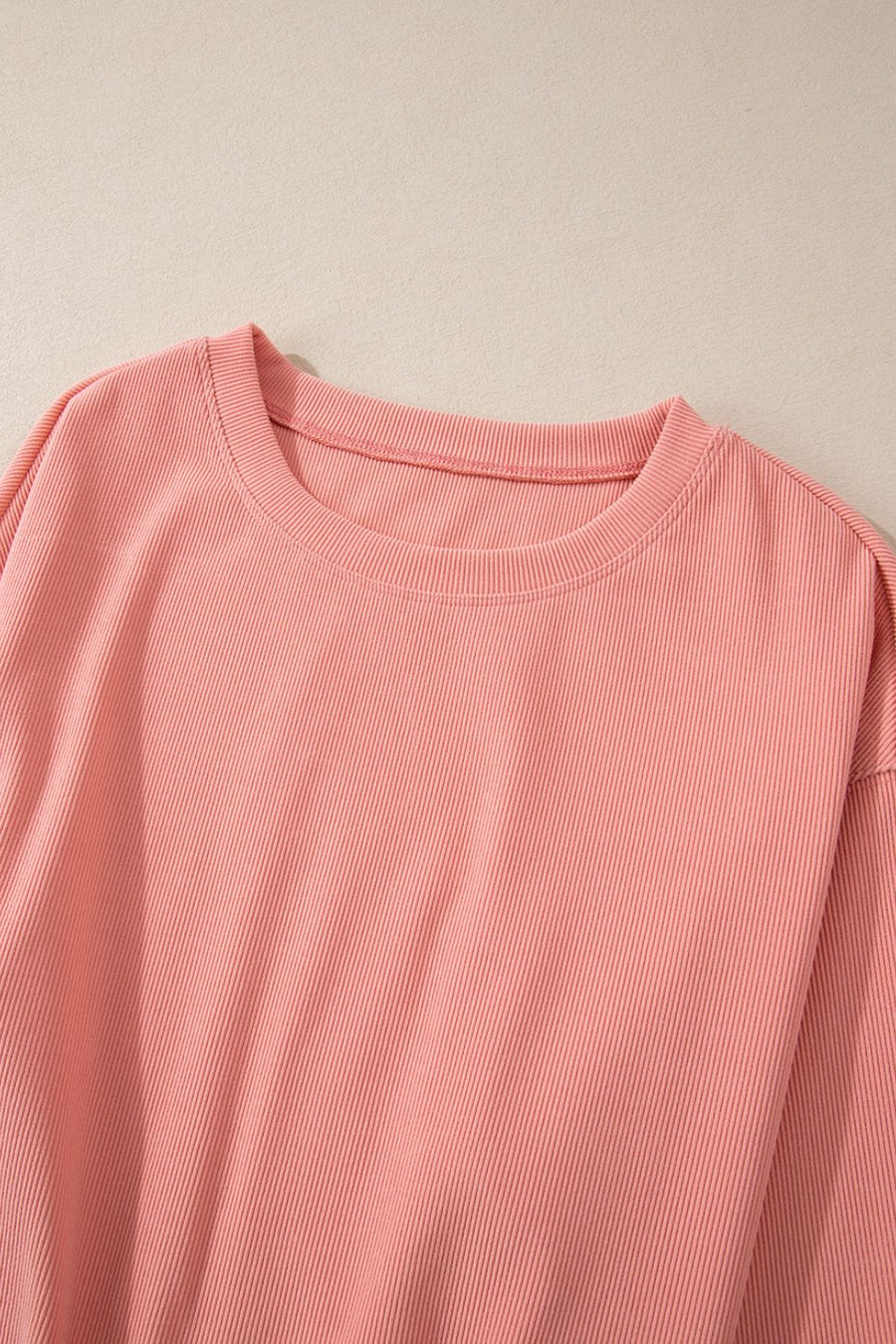Pink ribbed crewneck sweater with long sleeves