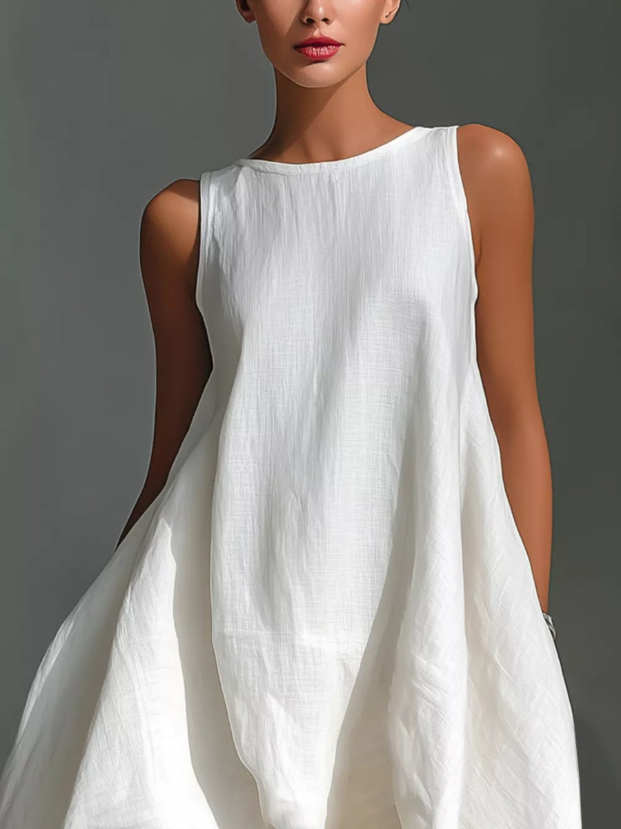 White asymmetrical sleeveless flowing dress with a relaxed fit and round neckline.