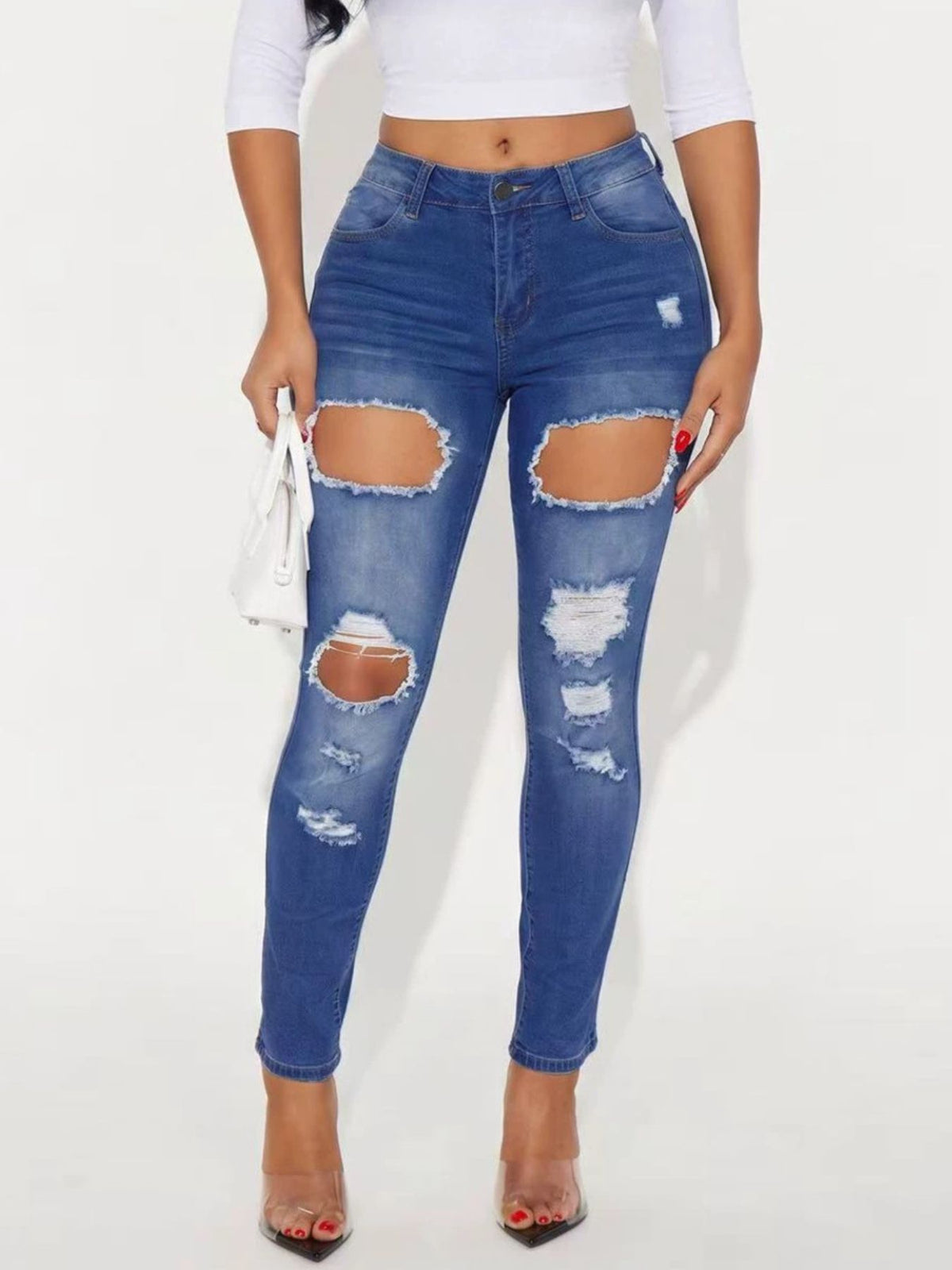 skinny jeans in medium blue featuring distressed and slim fit
