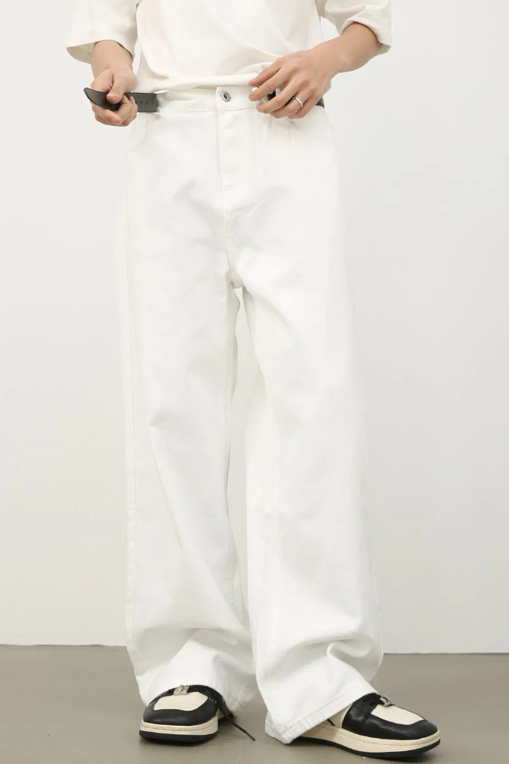 Sculpted wide leg ivory denim trousers with a relaxed fit and clean finish.