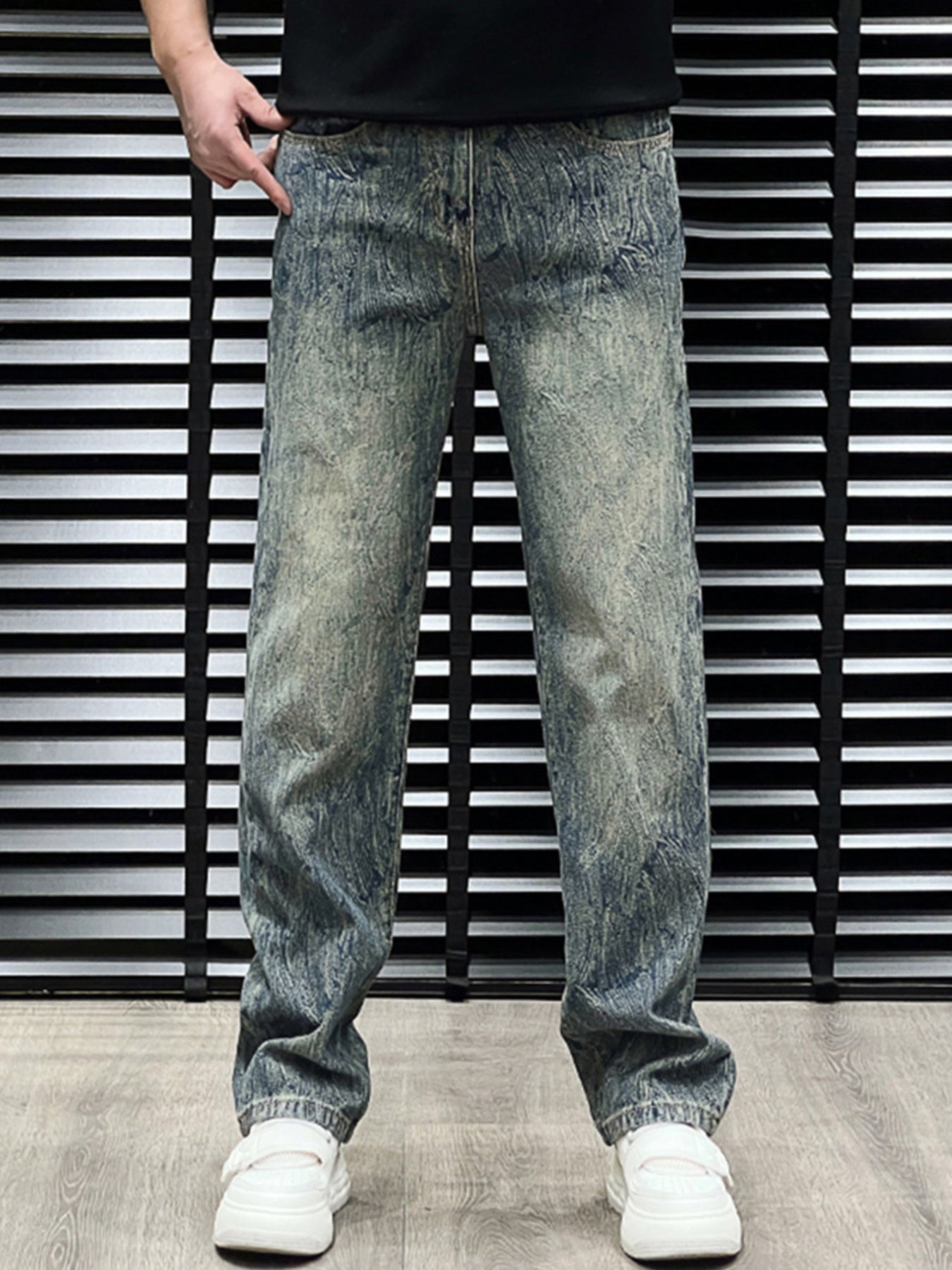 Men's relaxed fit vintage wash jeans in blue cotton with distressed details.